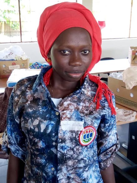 Een vrouw met een rode hoofddoek in Gambia.