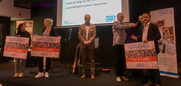 Drie prijswinners van de innovatiewedstrijd krijgen hun prijzen uitgereikt door Kees de Jong.
