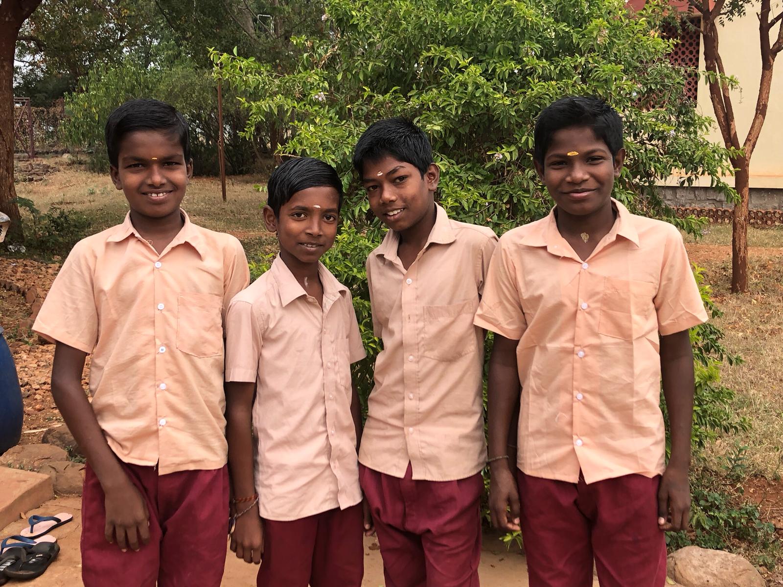Vier jongens in India in schooluniform.