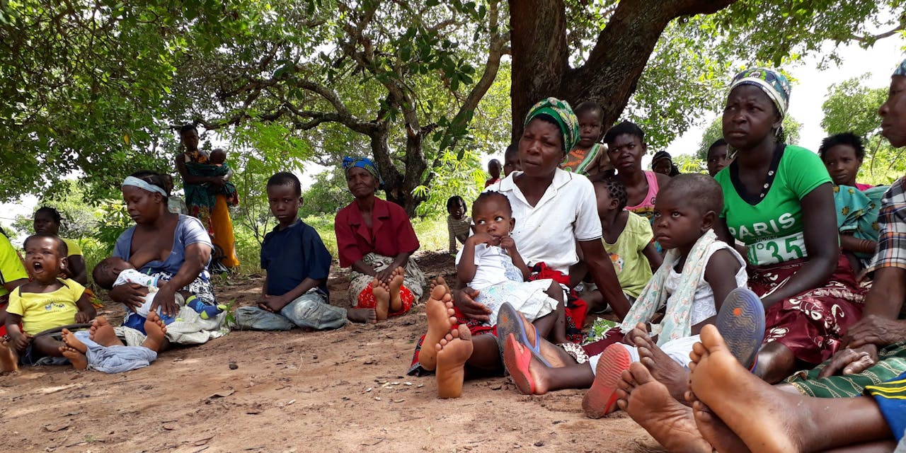 Een groep vrouwen wacht in een rij op zorg in Mozambique.