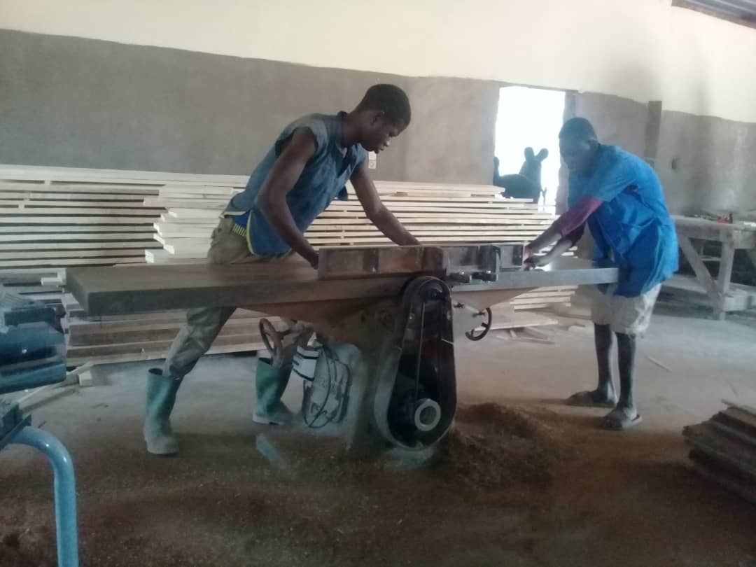 Jongeren bij een zaagmachine