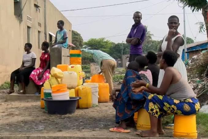 Een groep mensen in Congo met jerrycans om water te tillen
